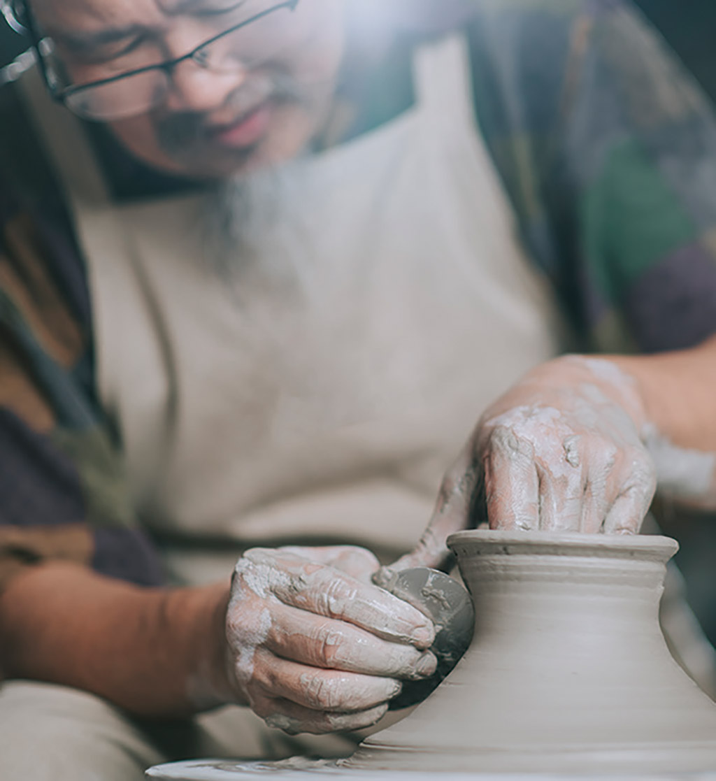 potter sculpting clay
