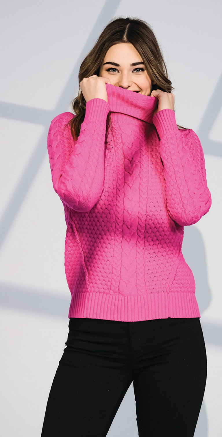 white woman in pink sweater and black pants